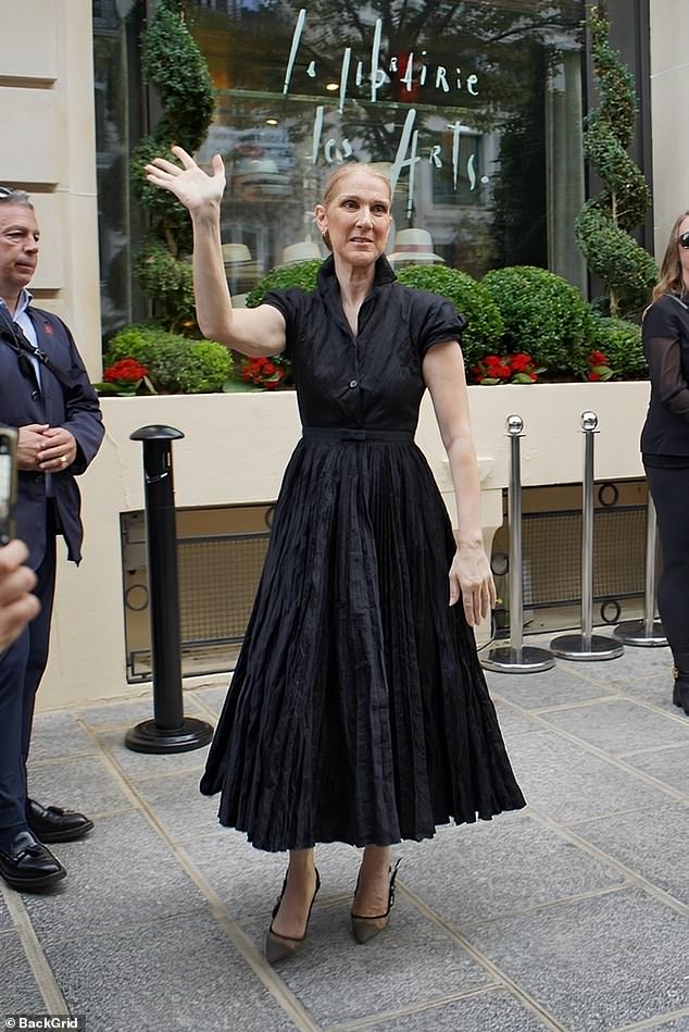 Celine - who has yet to make an official comment on the speculation - wore a black high-neck dress that was cinched at the waist and flared into a pleated skirt