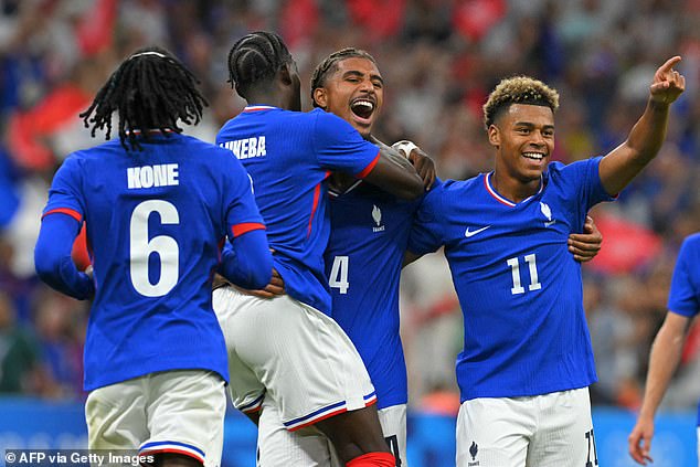 French defender #04 Loic Bade (C) celebrates his goal with teammates