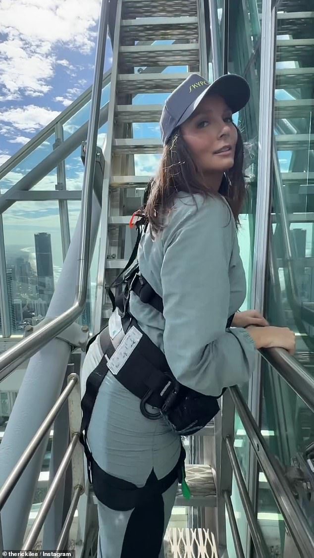 Wearing a gray jumpsuit and a black harness, the singer shook her behind for the camera as she backed down the steps of the SkyPoint Climb.