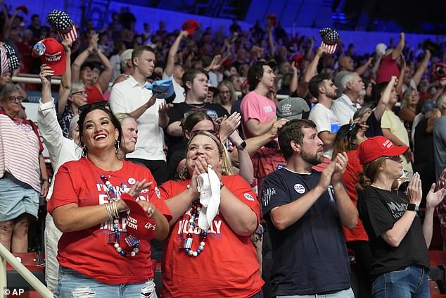 Trump's fans applaud after singing the national anthem and before he takes the stage