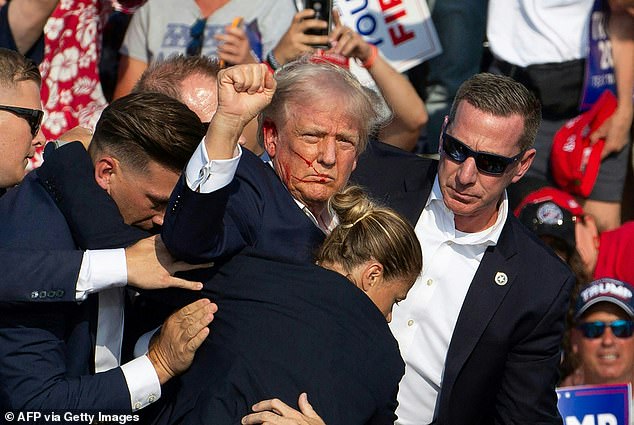 Trump raised his fist in the air and appeared to say “fight” before being escorted off the stage by security on July 13, 2024.