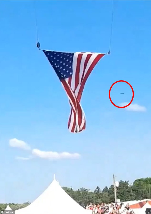 A disc-shaped object zoomed in the background of an American flag flapping in the wind shortly before bullets were fired and another appeared as an orb as the Secret Service stormed the stage