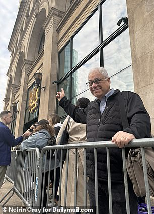 Michael Zorek, 63, stands in line outside the new Wegmans in Manhattan, preparing for its October 2023 opening.