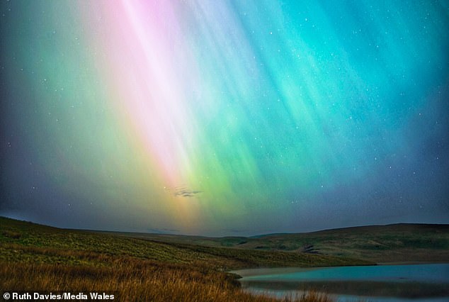 The Northern Lights, seen here over Denbigh Moors, Wales, are caused by charged particles from the sun colliding with our atmosphere