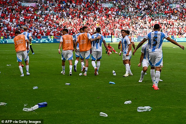 Cups and bottles of water were also thrown onto the pitch as the Argentina players celebrated