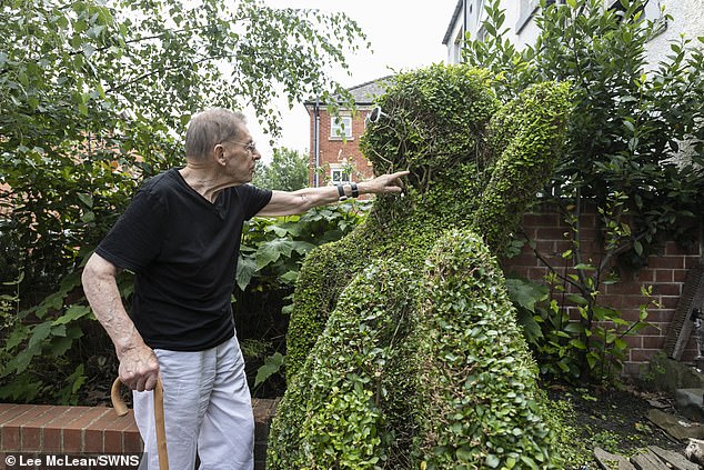 The statue is even bigger than the pensioner himself, with several people climbing on the tree and pretending to have sex with it