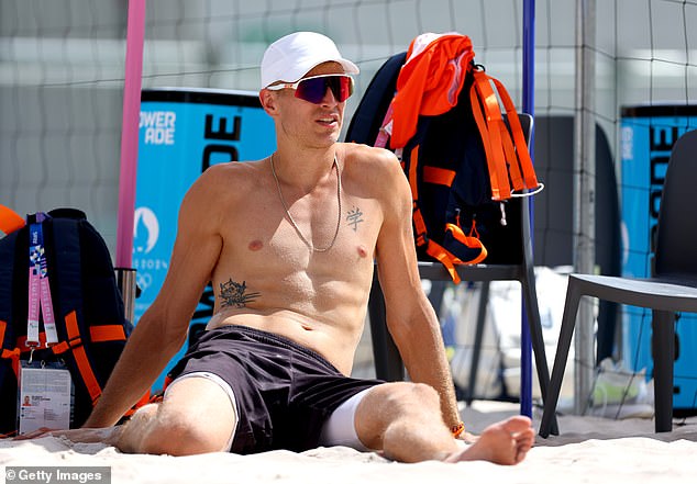 The Olympian was spotted stretching in the sand ahead of his training session with the Dutch volleyball team