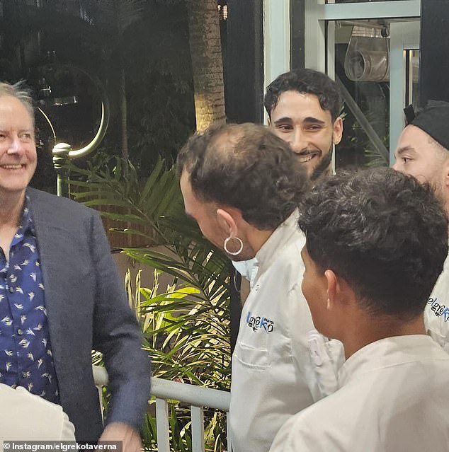 Anthony Albanese is pictured with restaurant staff while on vacation in Palm Cove on Saturday