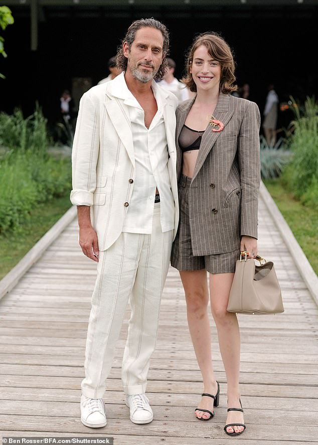 The beauty completed her outfit with a pair of black leather strappy sandals and wore a quirky lobster brooch on her suit (seen with Jonathan Schwartz)