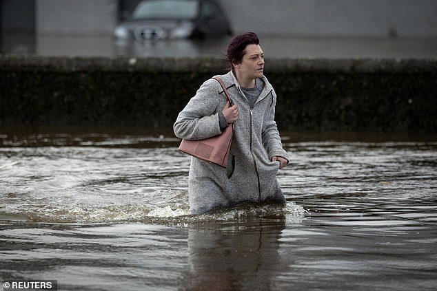 Storm Ciaran on November 2 had the potential to be as severe as the 'Great Storm' of October 16, 1997, the Met Office said, but the strongest winds missed the UK in the south. Pictured: A woman braves Storm Ciaran in Newry, Northern Ireland