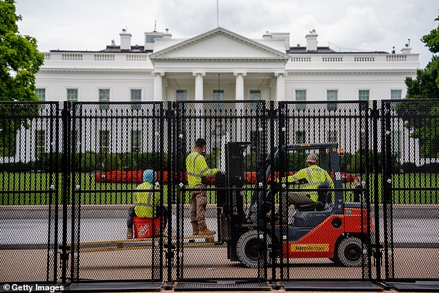 Workers install additional security fencing around the White House in preparation for Israeli Prime Minister Benjamin Netanyahu's visit