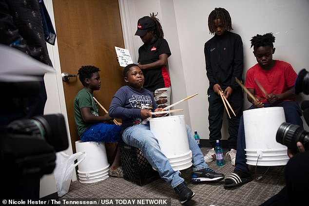 Detonio Wilson, 10, is seen here drumming on buckets along with the other young children abused by the group