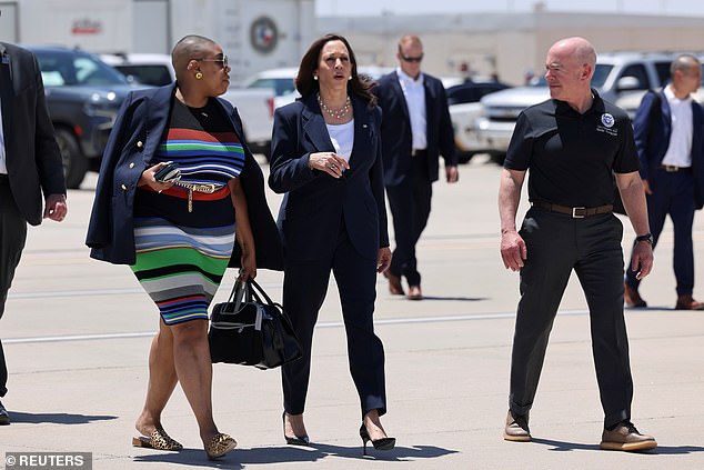 US Vice President Kamala Harris walks with Secretary of Homeland Security (DHS) Alejandro Mayorkas and spokesman Symone Sanders