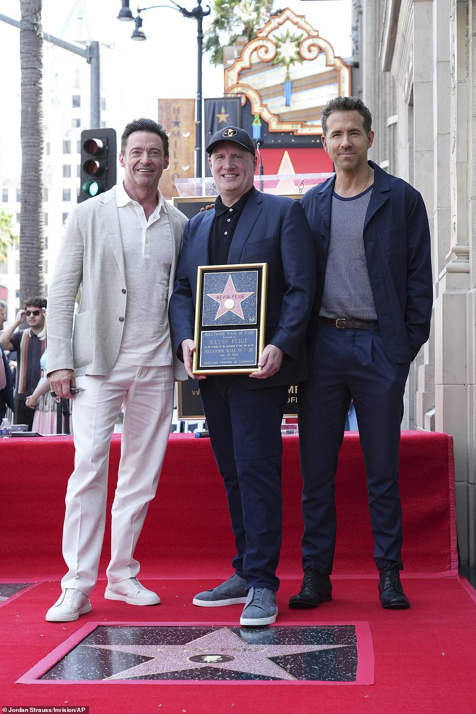 Feige was thrilled as he posed with Jackman and Reynolds