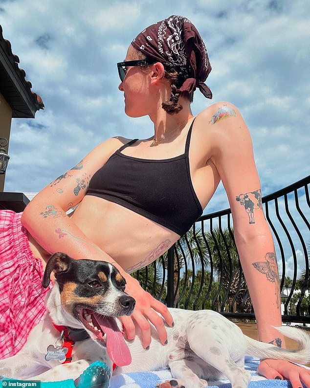 Artist and model Ella Emhoff, above with dog Jerry, on a beach trip and looking fashionable on the ski slopes, has said of her upbringing: 'I love my three parents'