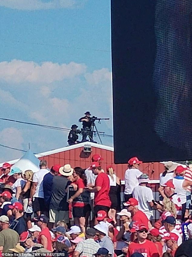 Snippers stand on a roof at the campaign rally of Republican presidential candidate and former US President Donald Trump