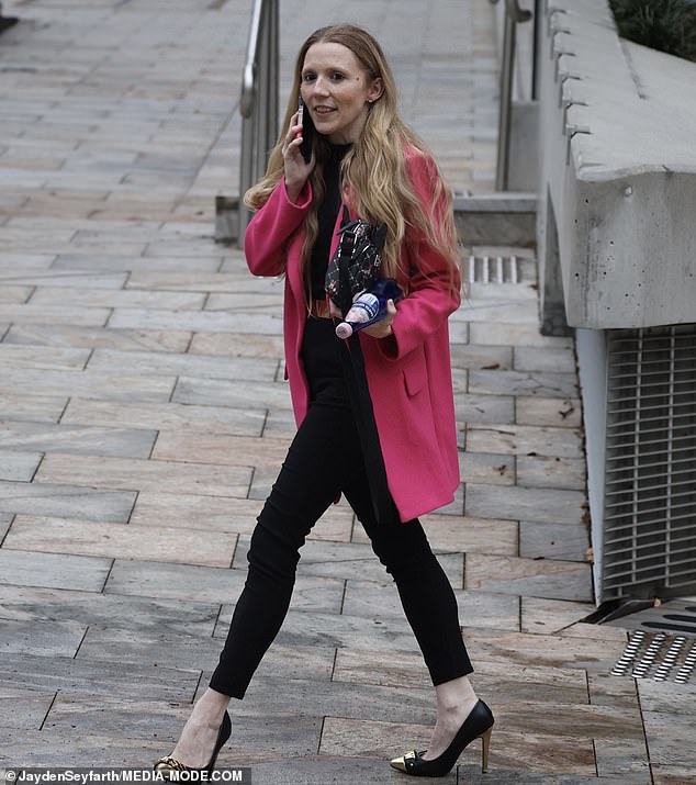 Nikki showed off her chic style in a bright pink coat paired with a black top and pants