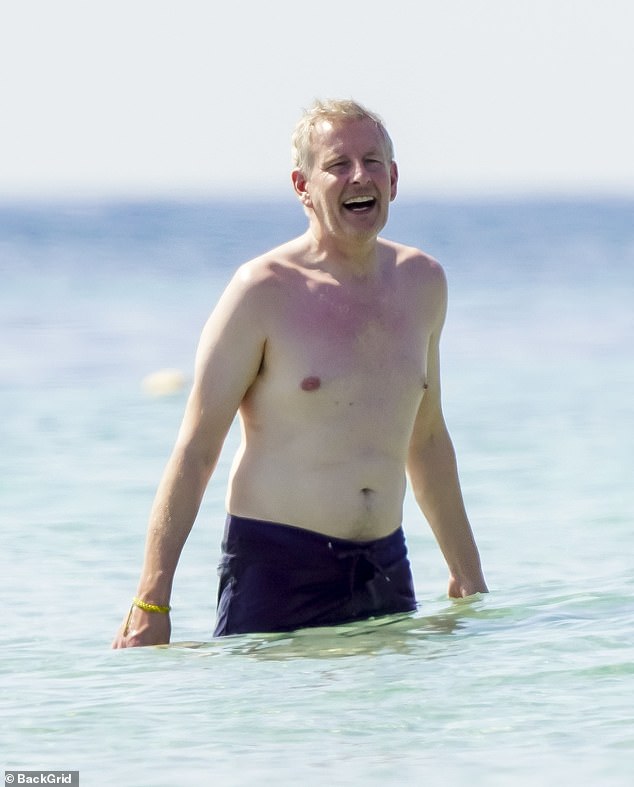 Meanwhile, her husband Patrick showed off his bare body as he headed into the ocean for a swim