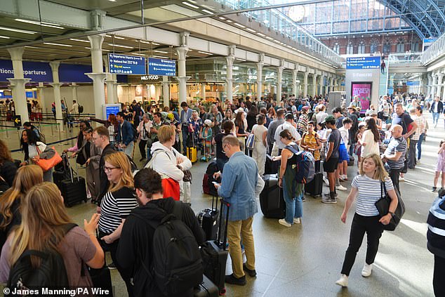 Passengers queue at the Eurostar terminal at St Pancras station in central London on Friday