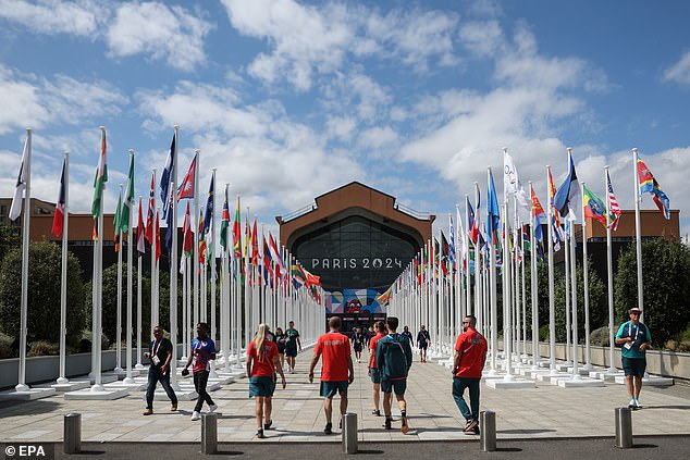 People walk in front of the canteen of the Olympic Village at the Athletes Village of the Paris 2024 Olympic Games in Saint Denis, France on Tuesday. The Summer Olympics are scheduled to take place from July 26 to August 11, 2024 in Paris