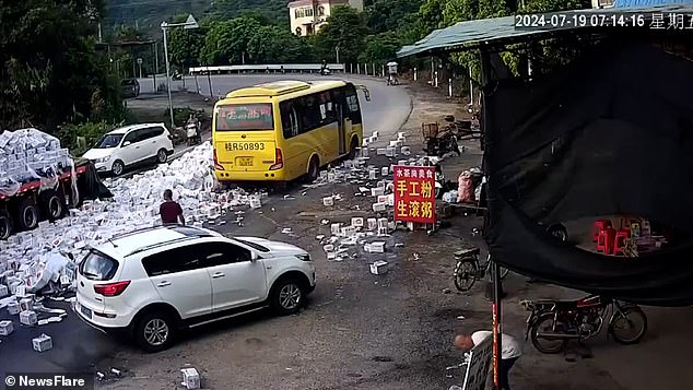 A yellow bus and a white hatchback car were driving past when the incident happened. Fortunately, both vehicles stopped and no one was injured.