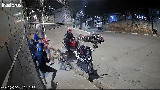 A group of people chatting next to a building sprang into action when two motorcycles collided head-on in Brazil. One of the motorcyclists was pronounced dead at the scene and another was injured and taken to a local hospital