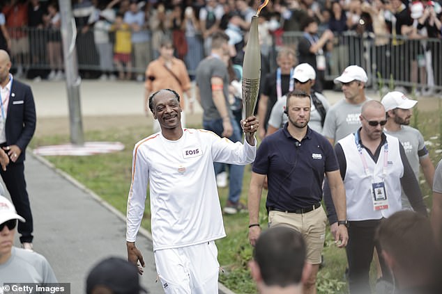 1721993971 510 Snoop Dogg carries Olympic torch ahead of opening ceremony in