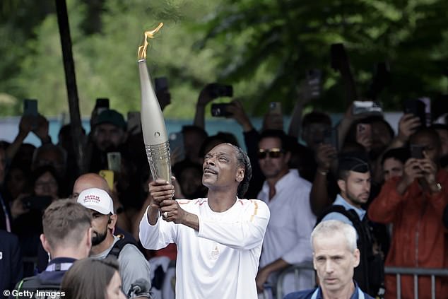 1721993978 6 Snoop Dogg carries Olympic torch ahead of opening ceremony in