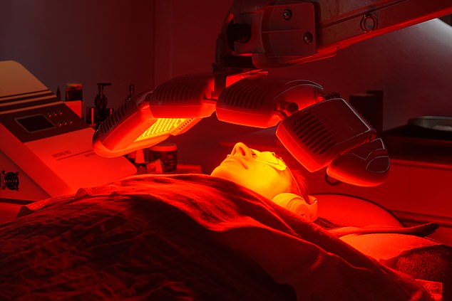 The facialist uses an LED light therapy device on Radhika's skin to increase collagen