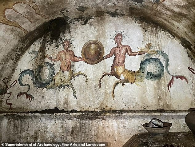 A sealed sarcophagus at the 'tomb of Cerberus', the three-headed dog from Greek mythology, has been opened - to the surprise of experts with mummies in 'excellent condition'. The long-sealed chamber, part of a necropolis decorated with ornate frescoes (above), was discovered outside Naples, Italy