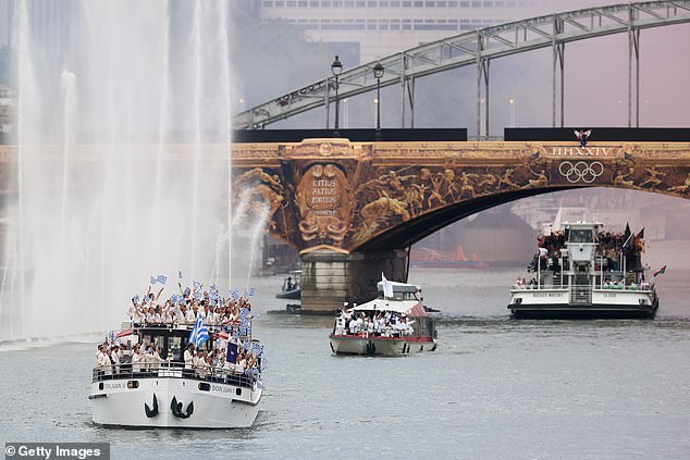 Pictured: Boats full of athletes sail down the City of Light's famous river - Australia is nowhere to be seen until the end of the ceremony