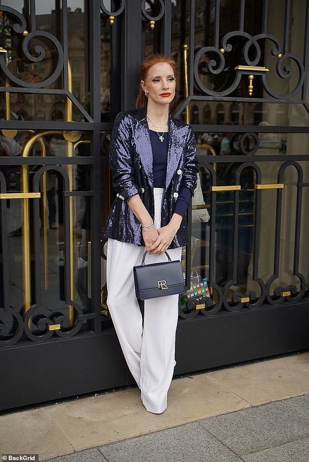 She had her red hair pulled back into a tight ponytail and wore layered silver and pearl necklaces