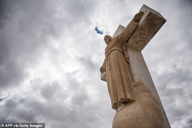 An 8-meter-high limestone statue of Jesus Christ stands on top of the mountain