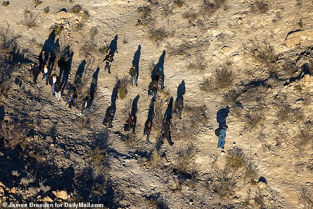 Illegal immigrants trek through the hills of Mount Cristo Rey in Sunland Park, New Mexico