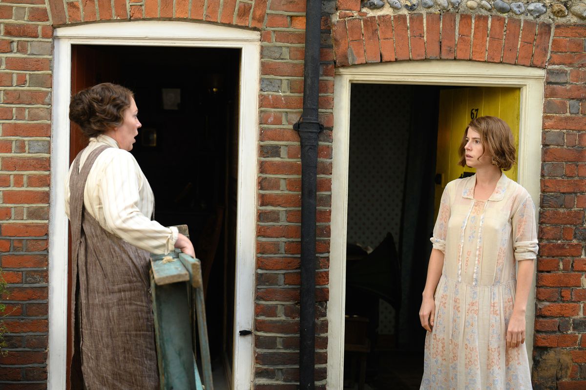 Terraced house neighbors Edith (Olivia Colman) and Rose (Jessie Buckley) face off at their adjacent front doors in Wicked Little Letters