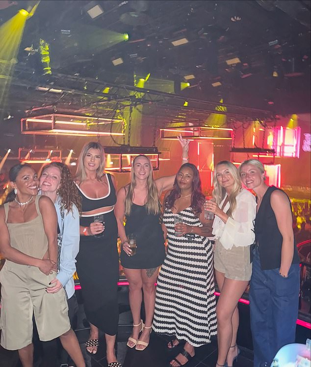 Lioness Leah Williamson (far right) also joined the gang for the well-deserved outing, with the group posing for a glamorous photo in a nightclub