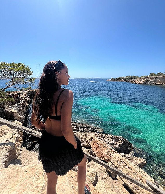 One photo the ex-footballer shared featured a snap of herself showing off her toned figure in a black bikini and shorts as she looked out over the sea