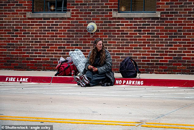 Now, there are approximately 1.4 thousand people in the city who are homeless on any given night. Pictured: A homeless woman sits on a curb on a street in Oklahoma City in 2019