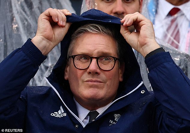 Starmer sought shelter from the downpour at the Olympic Games opening ceremony on Friday night under a Team GB raincoat, while those around him quickly donned clear plastic ponchos