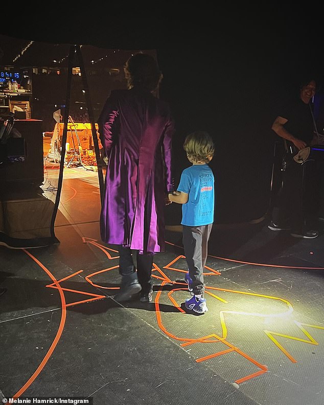 This was followed by a heartbreaking photo of Mick holding his son's hand backstage, just before the stage entrance.