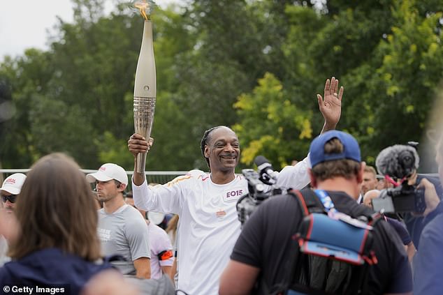 The legendary rapper was one of the people who carried the torch through Paris this week