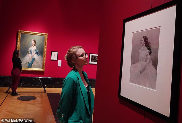 A visitor views a portrait by Paolo Roversi of the Duchess of Cambridge in November 2021