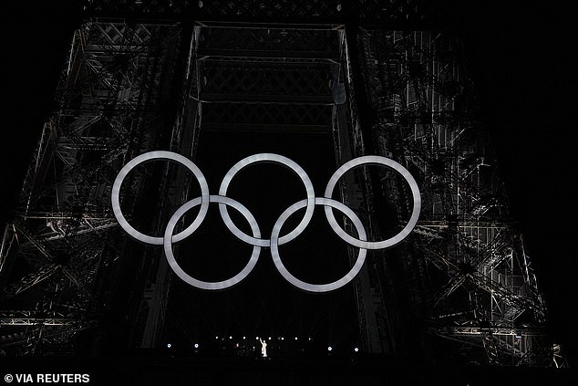 The Olympic rings are seen on the Eiffel Tower during last night's opening ceremony