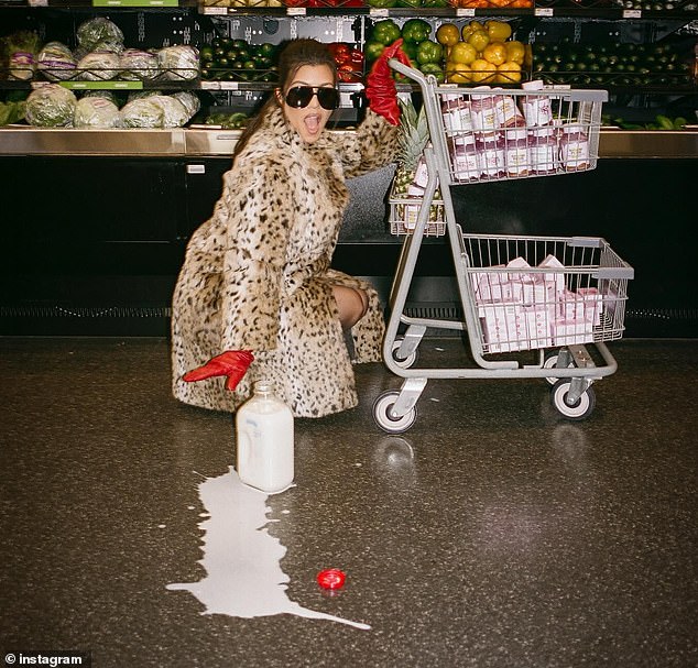 1722143996 971 Kourtney Kardashian models faux fur coat and red gloves during