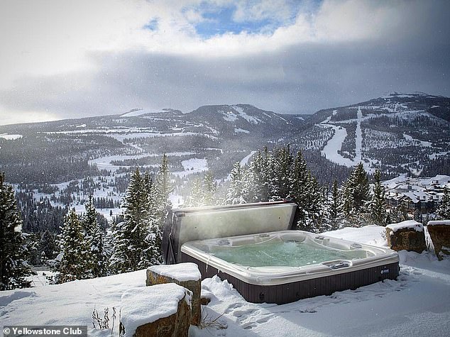 Yellowstone Club members can relax in a hot tub overlooking Montana's snow-capped mountains