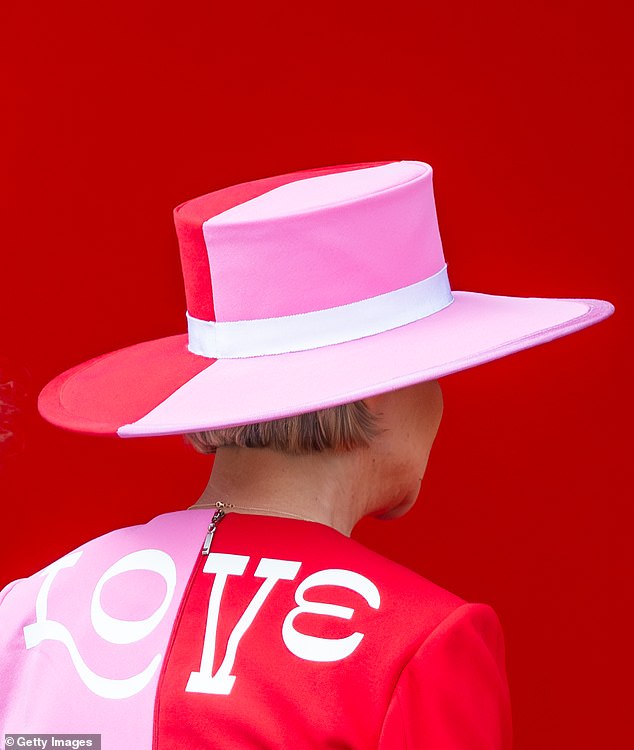 Princess Delphine wore a dazzling pink and red outfit with the word 'love' on the back, three years after she was officially named daughter of the former monarch