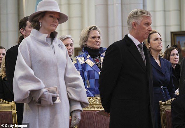 The artist, formerly known as Delphine Boël, is depicted (center) with her half-brother (front right) King Philippe of Belgium