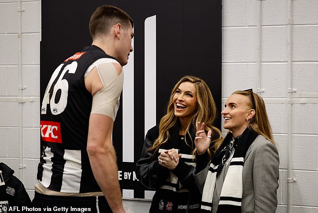 The blonde beauty carried a very striking black and white Prada handbag to match her Collingwood scarf