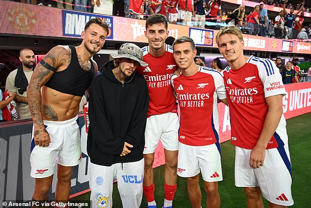 Bieber was among the stars in the stands for the match and was seen taking pictures with (L-R) Ben White, Kai Havertz, Leandro Trossard and Odegaard