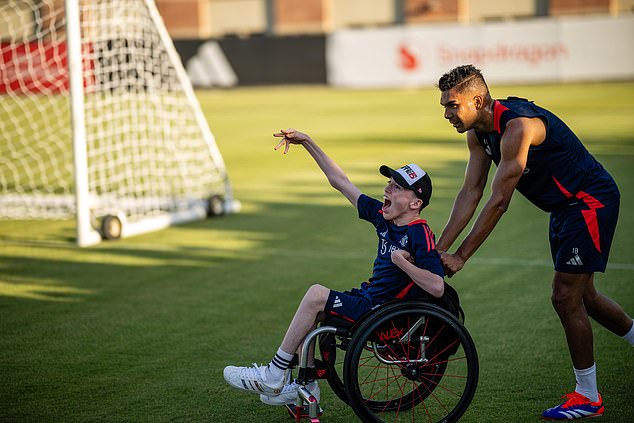 United players took disabled supporter Alex Nield onto the pitch for photographs after Casemiro spotted him in the stands during an open training session on Friday